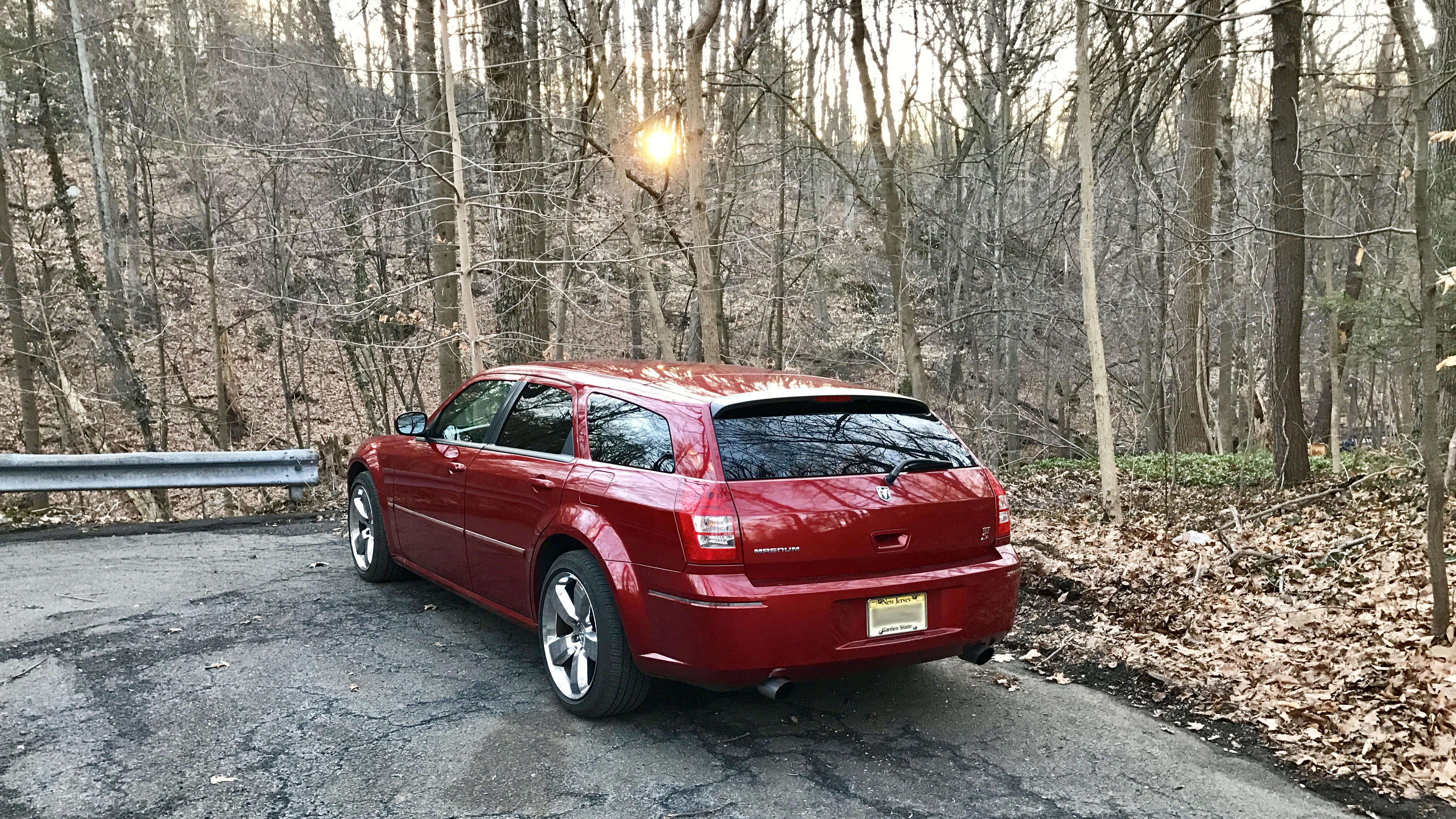 red car forest sunset